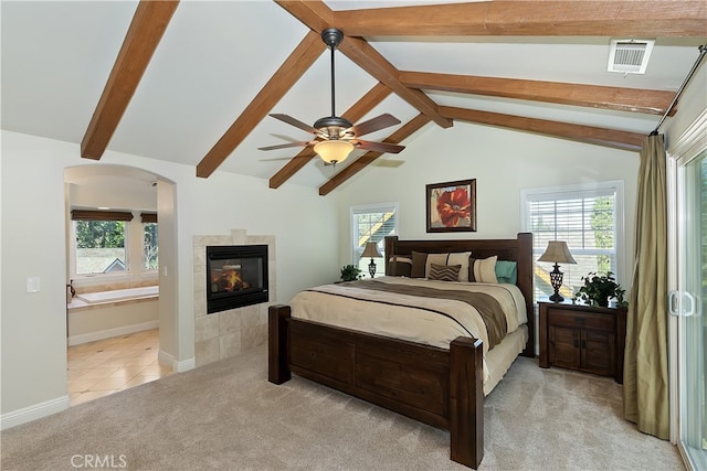 bedroom featuring a fireplace, vaulted ceiling with beams, visible vents, light carpet, and baseboards