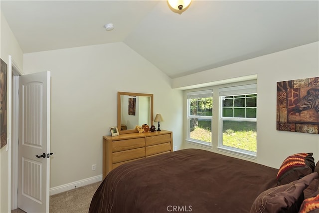 bedroom with carpet flooring, baseboards, and lofted ceiling