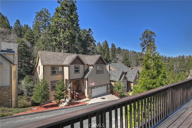 wooden terrace with driveway and a garage