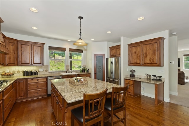 455 Clearwater Ln, Lake Arrowhead, CA 92352 - kitchen with appliances with stainless steel finishes, a center island, dark wood finished floors, recessed lighting, and light stone countertops