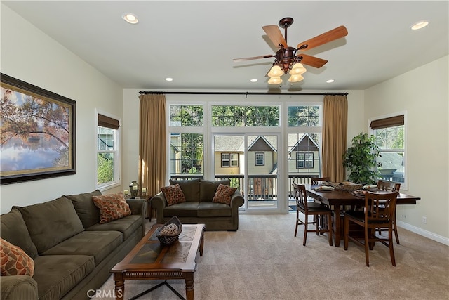 living room featuring light colored carpet, recessed lighting, a ceiling fan, and baseboards
