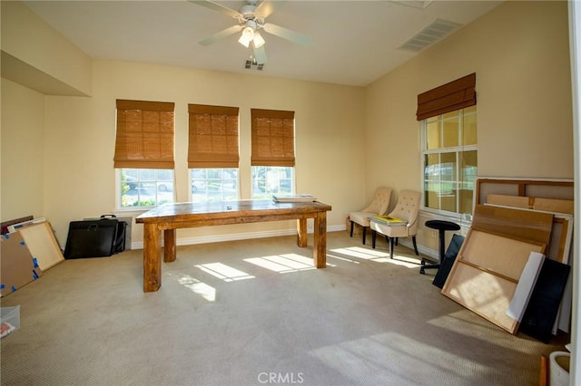 carpeted office space featuring visible vents, ceiling fan, and baseboards
