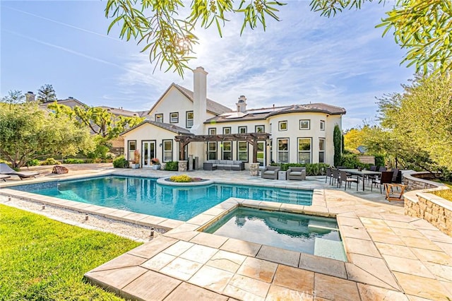 outdoor pool with a patio, an outdoor living space, an in ground hot tub, and a pergola