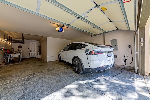 garage with a garage door opener and electric panel