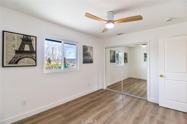 unfurnished bedroom with light wood finished floors, visible vents, and baseboards