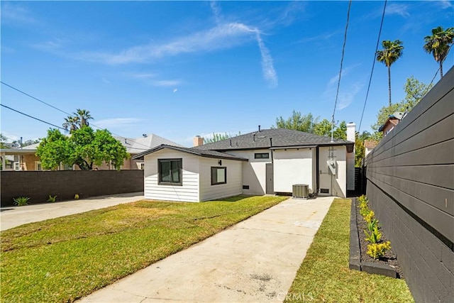 4926 Templeton St, Los Angeles, CA 90032 - view of front of property featuring concrete driveway, a chimney, a front yard, fence, and central AC