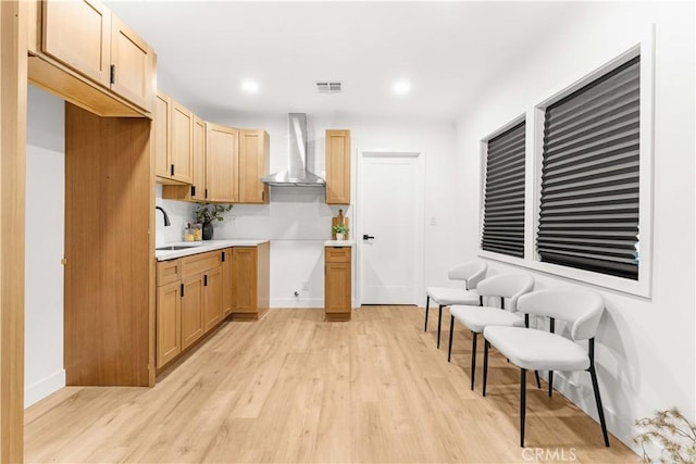4926 Templeton St, Los Angeles, CA 90032 - kitchen featuring baseboards, light wood-type flooring, wall chimney exhaust hood, and a sink