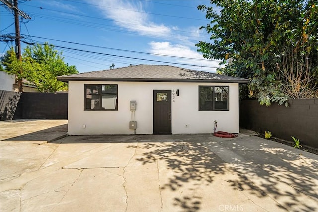 4926 Templeton St, Los Angeles, CA 90032 - bungalow-style home featuring stucco siding, a patio area, a shingled roof, and a fenced backyard