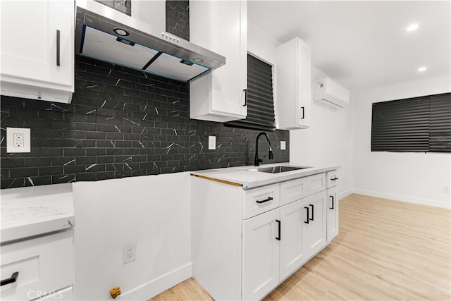 4926 Templeton St, Los Angeles, CA 90032 - kitchen with exhaust hood, light wood finished floors, a sink, and baseboards