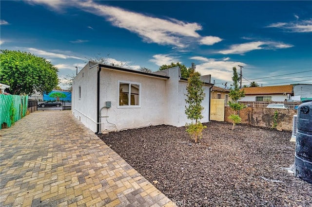 view of front of house featuring fence and stucco siding