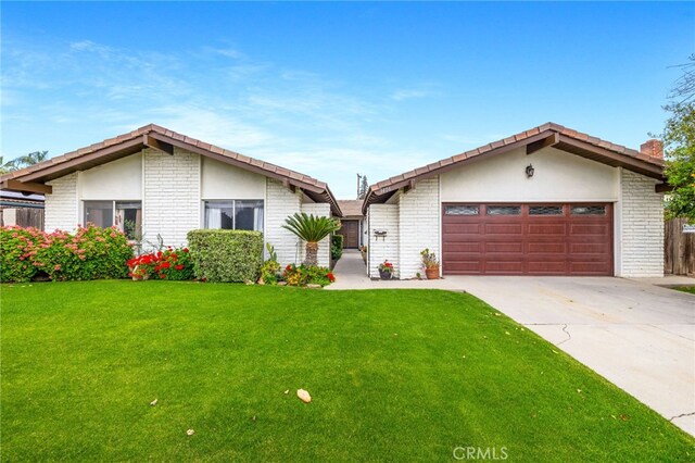 3406 Elm St, Bakersfield, CA 93301 - single story home with driveway, a front lawn, an attached garage, and brick siding