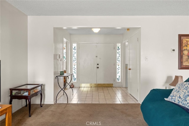 3406 Elm St, Bakersfield, CA 93301 - carpeted entrance foyer with a textured ceiling, tile patterned floors, and baseboards