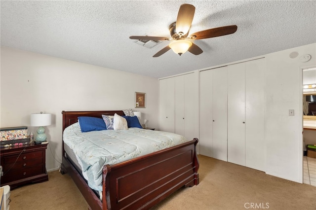 3406 Elm St, Bakersfield, CA 93301 - bedroom featuring visible vents, a textured ceiling, carpet, and two closets