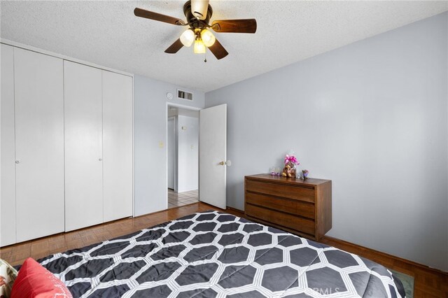 3406 Elm St, Bakersfield, CA 93301 - bedroom with visible vents, ceiling fan, a textured ceiling, and a closet