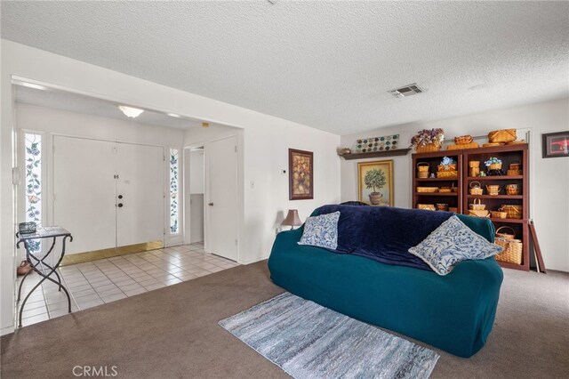 3406 Elm St, Bakersfield, CA 93301 - carpeted living area featuring tile patterned floors, visible vents, and a textured ceiling