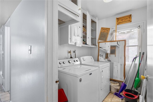 3406 Elm St, Bakersfield, CA 93301 - laundry area featuring washer and dryer, cabinet space, and light tile patterned flooring