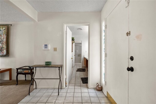 3406 Elm St, Bakersfield, CA 93301 - foyer with light tile patterned flooring, a textured ceiling, and baseboards