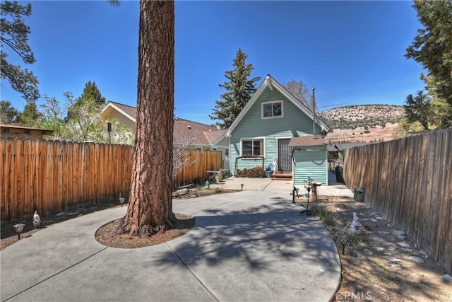 view of front of house with a patio and a fenced backyard