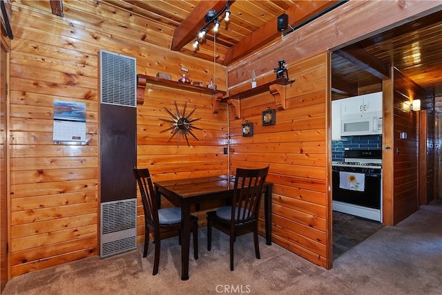 dining space featuring a heating unit, wooden walls, carpet flooring, and wooden ceiling