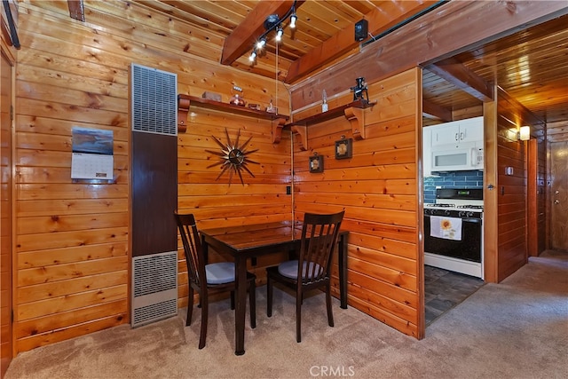 carpeted dining space featuring wooden ceiling, wooden walls, and a heating unit
