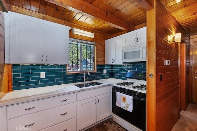 kitchen featuring tasteful backsplash, white microwave, wood ceiling, gas range oven, and a sink