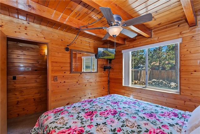 bedroom featuring beam ceiling, wooden walls, and wooden ceiling