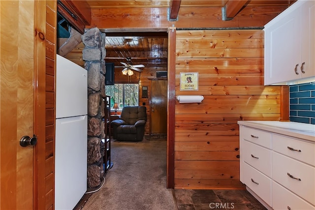 corridor featuring dark carpet, wooden walls, and wood ceiling