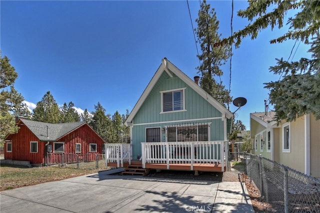 view of front of house featuring a deck and fence