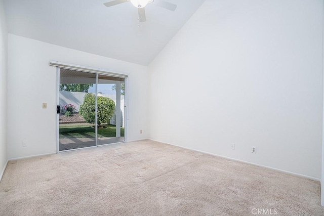 carpeted empty room featuring a ceiling fan, high vaulted ceiling, and baseboards