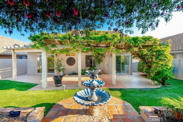 rear view of house with a patio, fence, a yard, and a pergola