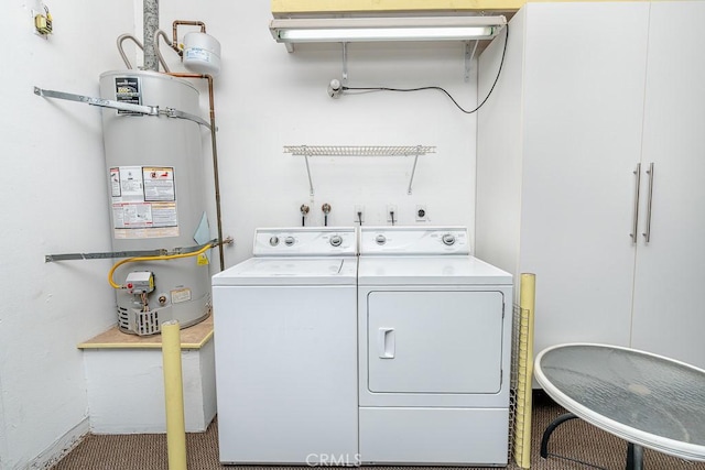 laundry room with washing machine and dryer, laundry area, and strapped water heater