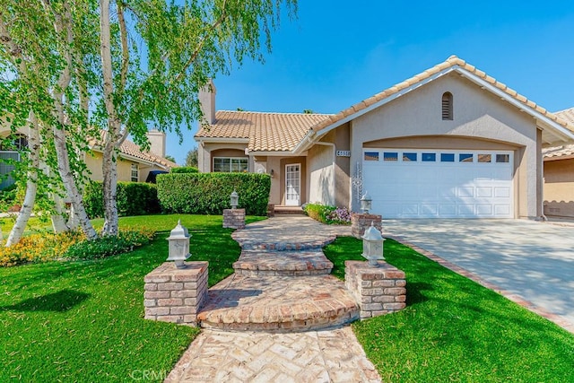mediterranean / spanish-style house featuring driveway, a tiled roof, a front yard, stucco siding, and a garage