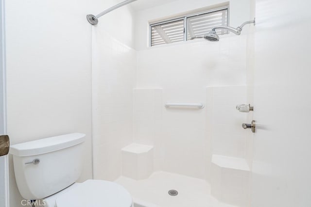 bathroom featuring toilet and a shower