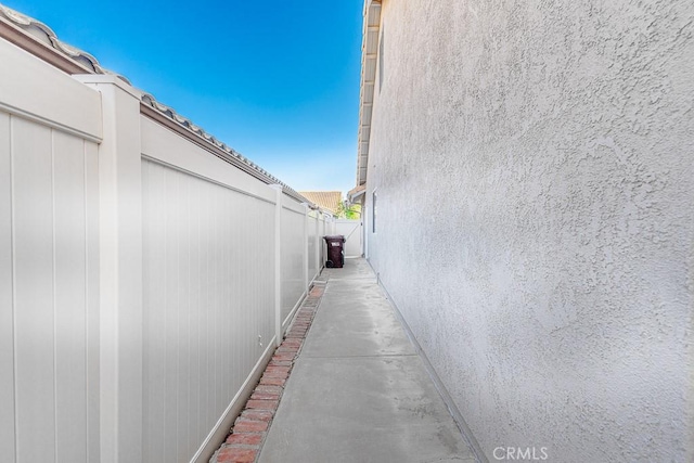 view of side of home featuring fence