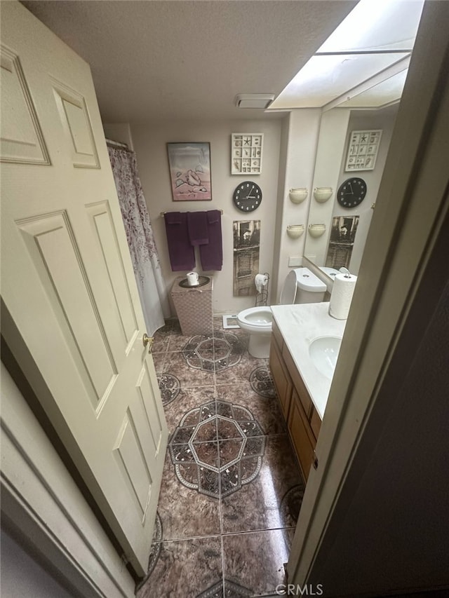 bathroom featuring toilet, visible vents, and vanity
