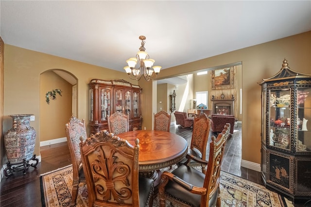 33931 Baystone St, Temecula, CA 92592 - dining space featuring a chandelier, wood finished floors, baseboards, and arched walkways