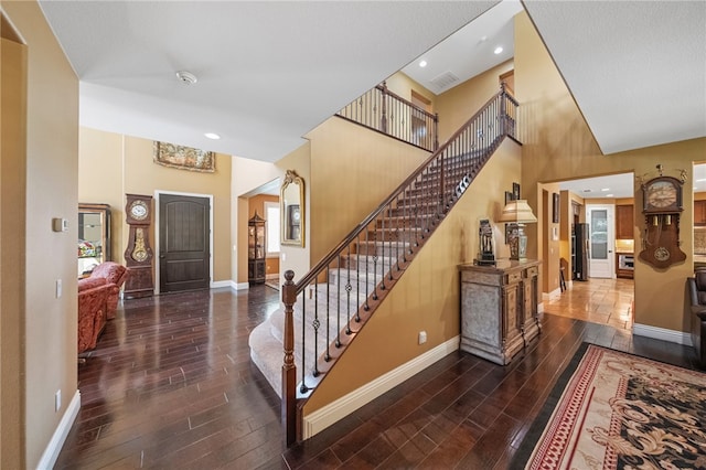 33931 Baystone St, Temecula, CA 92592 - foyer with wood-type flooring, stairway, a towering ceiling, and recessed lighting