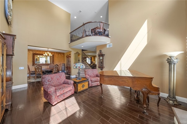 33931 Baystone St, Temecula, CA 92592 - living area featuring stairs, a towering ceiling, a chandelier, wood finished floors, and baseboards