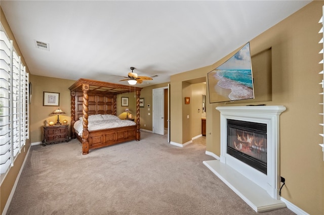 33931 Baystone St, Temecula, CA 92592 - bedroom with light colored carpet, a glass covered fireplace, baseboards, and a ceiling fan