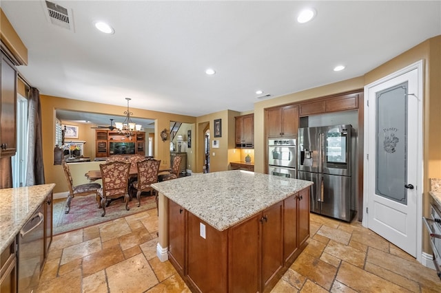 33931 Baystone St, Temecula, CA 92592 - kitchen featuring appliances with stainless steel finishes, stone tile floors, a kitchen island, light stone counters, and recessed lighting