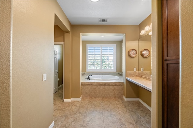 33931 Baystone St, Temecula, CA 92592 - full bath featuring a garden tub, vanity, tile patterned floors, and baseboards