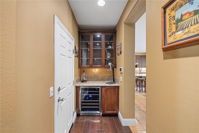 33931 Baystone St, Temecula, CA 92592 - indoor wet bar with wine cooler, dark wood-type flooring, and a textured wall