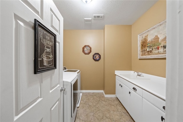 33931 Baystone St, Temecula, CA 92592 - laundry room featuring washer and dryer, cabinet space, a textured ceiling, and baseboards