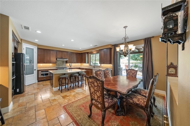 33931 Baystone St, Temecula, CA 92592 - dining area featuring a chandelier, stone tile floors, recessed lighting, and baseboards