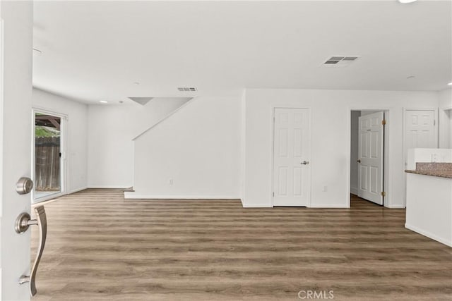 26145 Gravett Pl, Saugus, CA 91350 - unfurnished living room with wood finished floors, visible vents, and baseboards