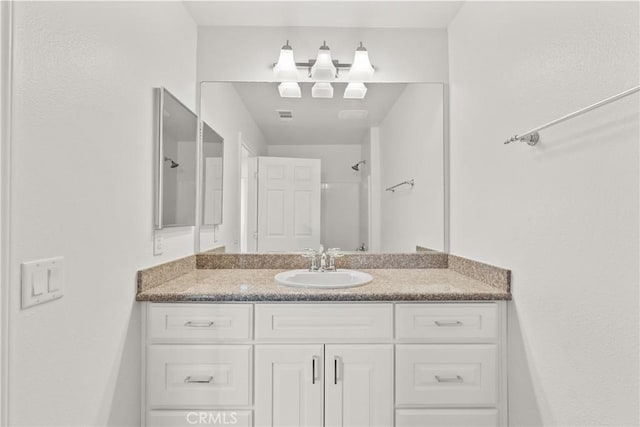26145 Gravett Pl, Saugus, CA 91350 - bathroom featuring walk in shower, visible vents, and vanity