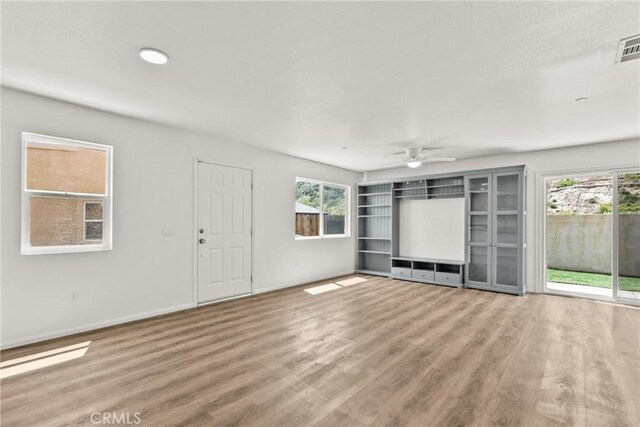 26145 Gravett Pl, Saugus, CA 91350 - unfurnished living room featuring baseboards, wood finished floors, and ceiling fan