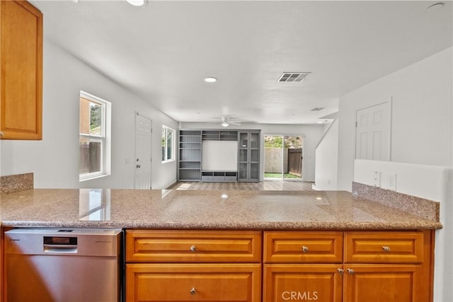 26145 Gravett Pl, Saugus, CA 91350 - kitchen with light stone countertops, ceiling fan, visible vents, a peninsula, and dishwashing machine