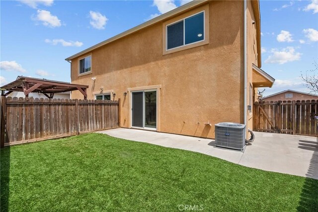 26145 Gravett Pl, Saugus, CA 91350 - back of property featuring stucco siding, a patio area, a yard, and a fenced backyard