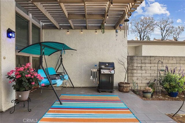 view of patio with a pergola, a grill, and fence